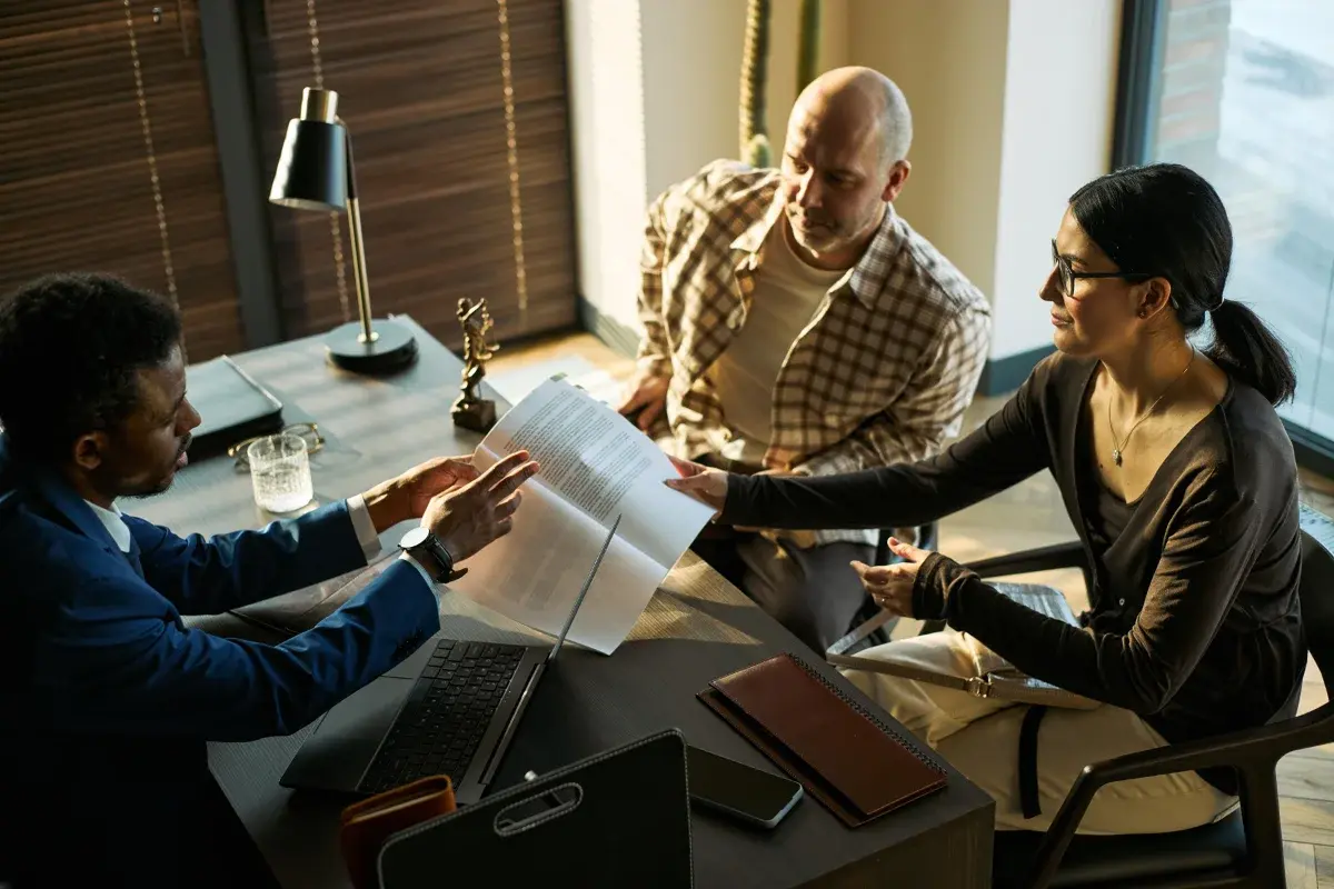 Personal injury attorneys reviewing a case file with a client
